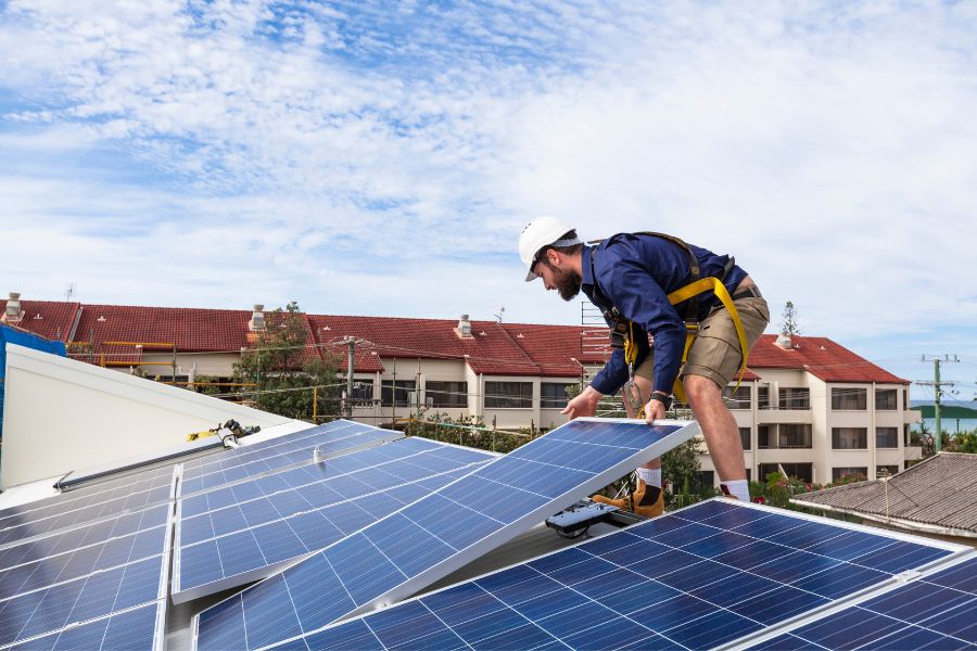 a man fixing solar panels