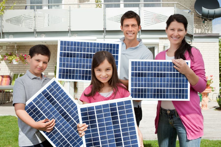 family holding solar panels